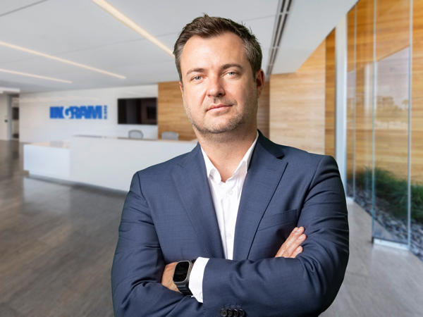 a person in a suit with his arms crossed