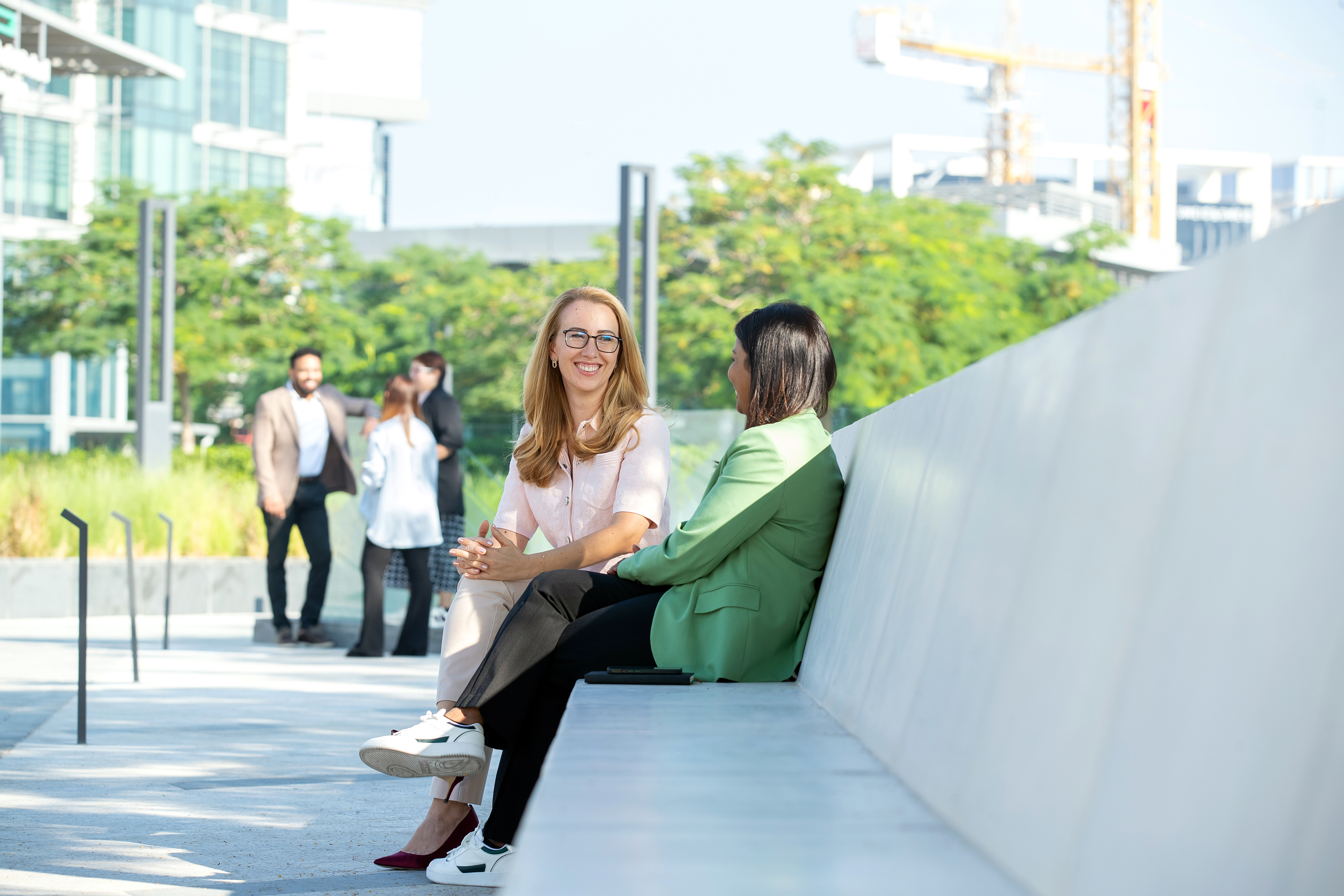 two women sitting on a bench
