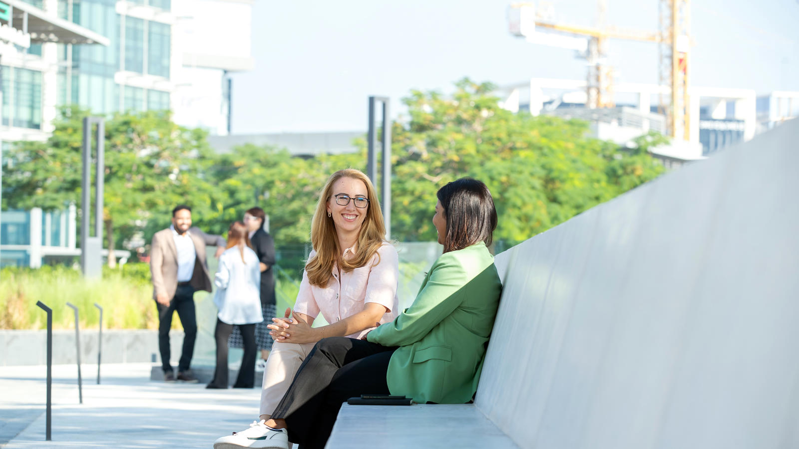two women sitting on a bench