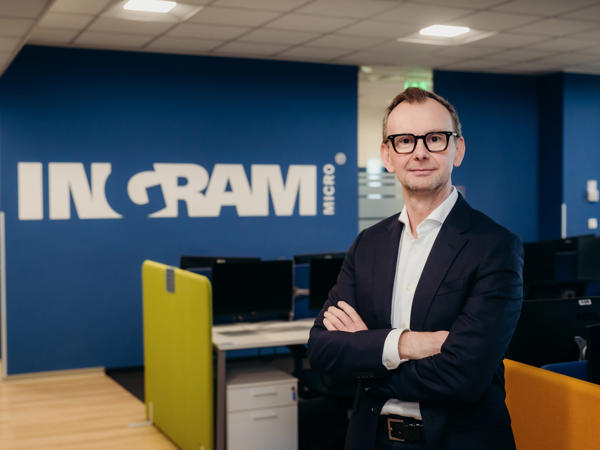 a person in a suit with his arms crossed