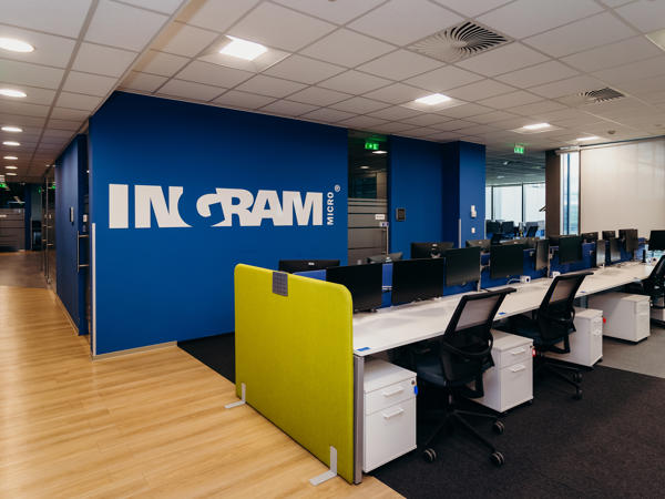 a room with a blue wall and white desks