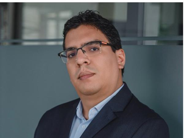 a person in a suit with his arms crossed