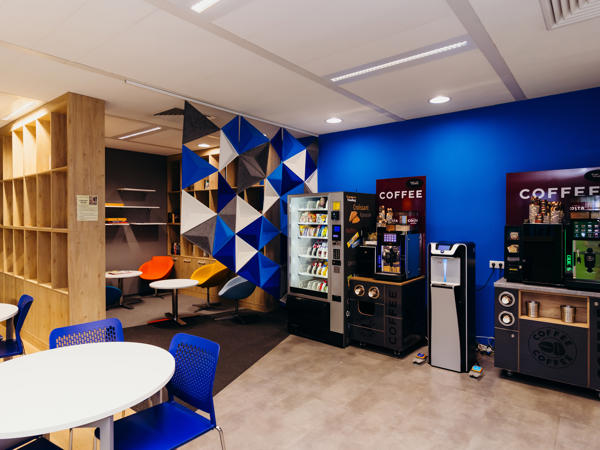 a room with a blue wall and a white table and chairs