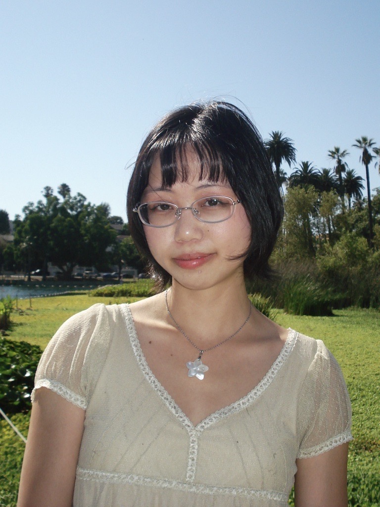 a person wearing glasses and a white shirt