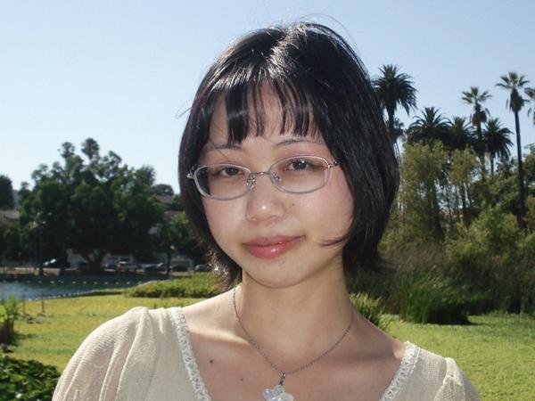 a person wearing glasses and a white shirt
