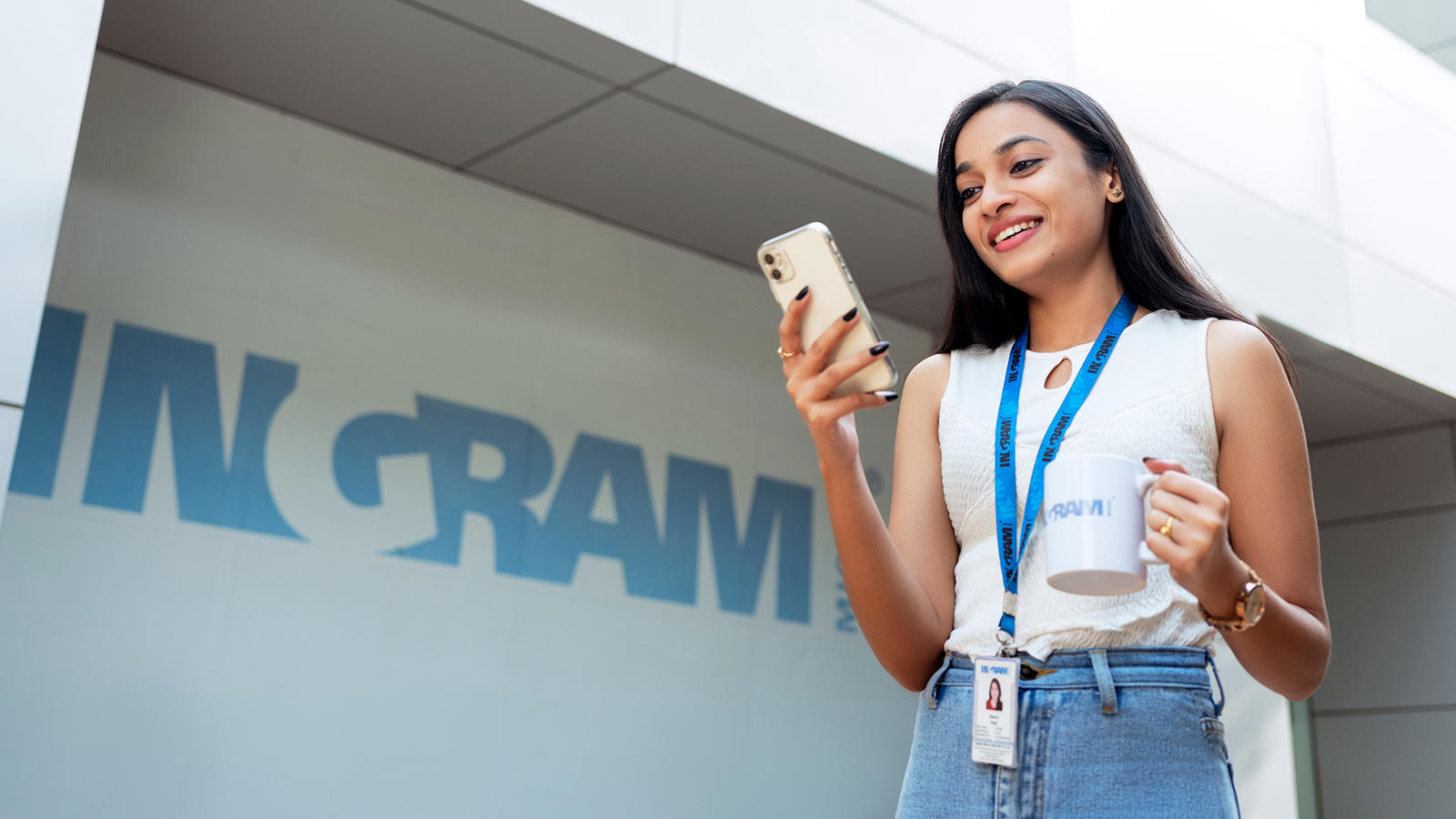 a person holding a phone and a mug