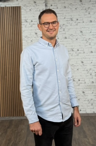 a person wearing glasses and a blue shirt