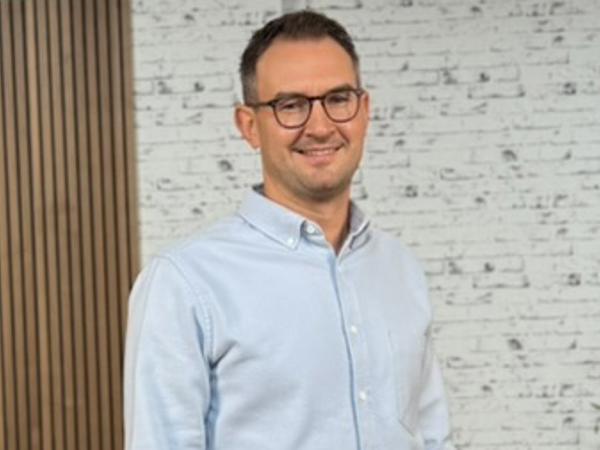 a person wearing glasses and a blue shirt
