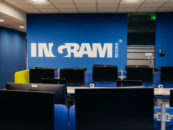 a room with computers and a blue wall
