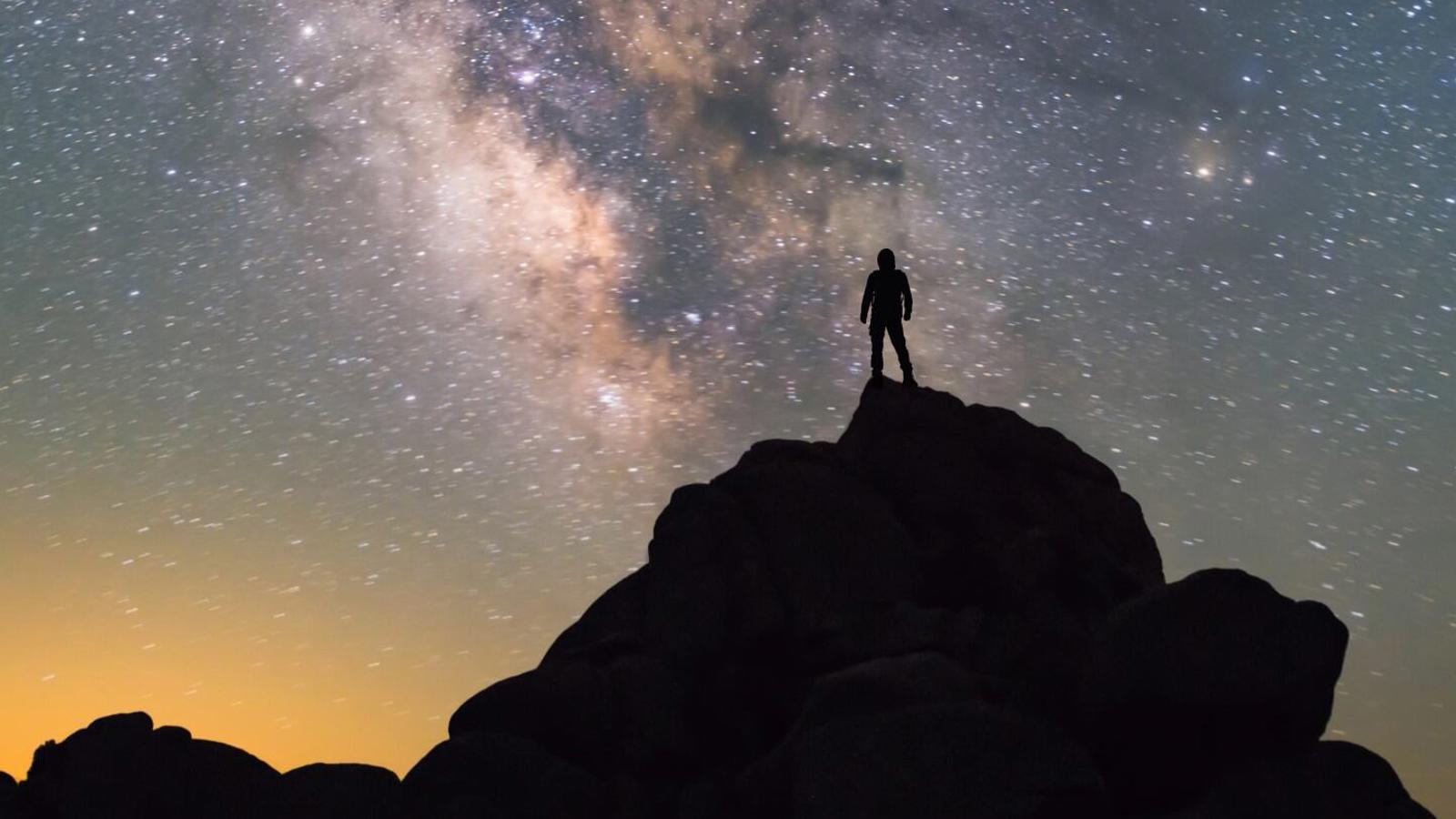 a person standing on a rock