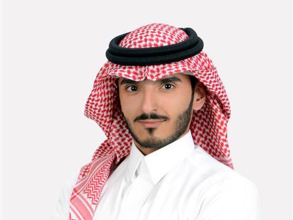 a person with a beard wearing a red and white headdress