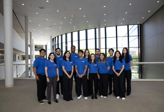 a group of people in blue shirts
