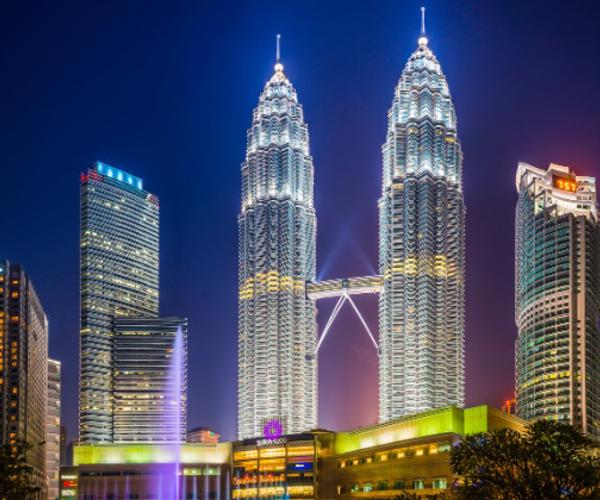 Petronas Towers skyline with a fountain and two towers