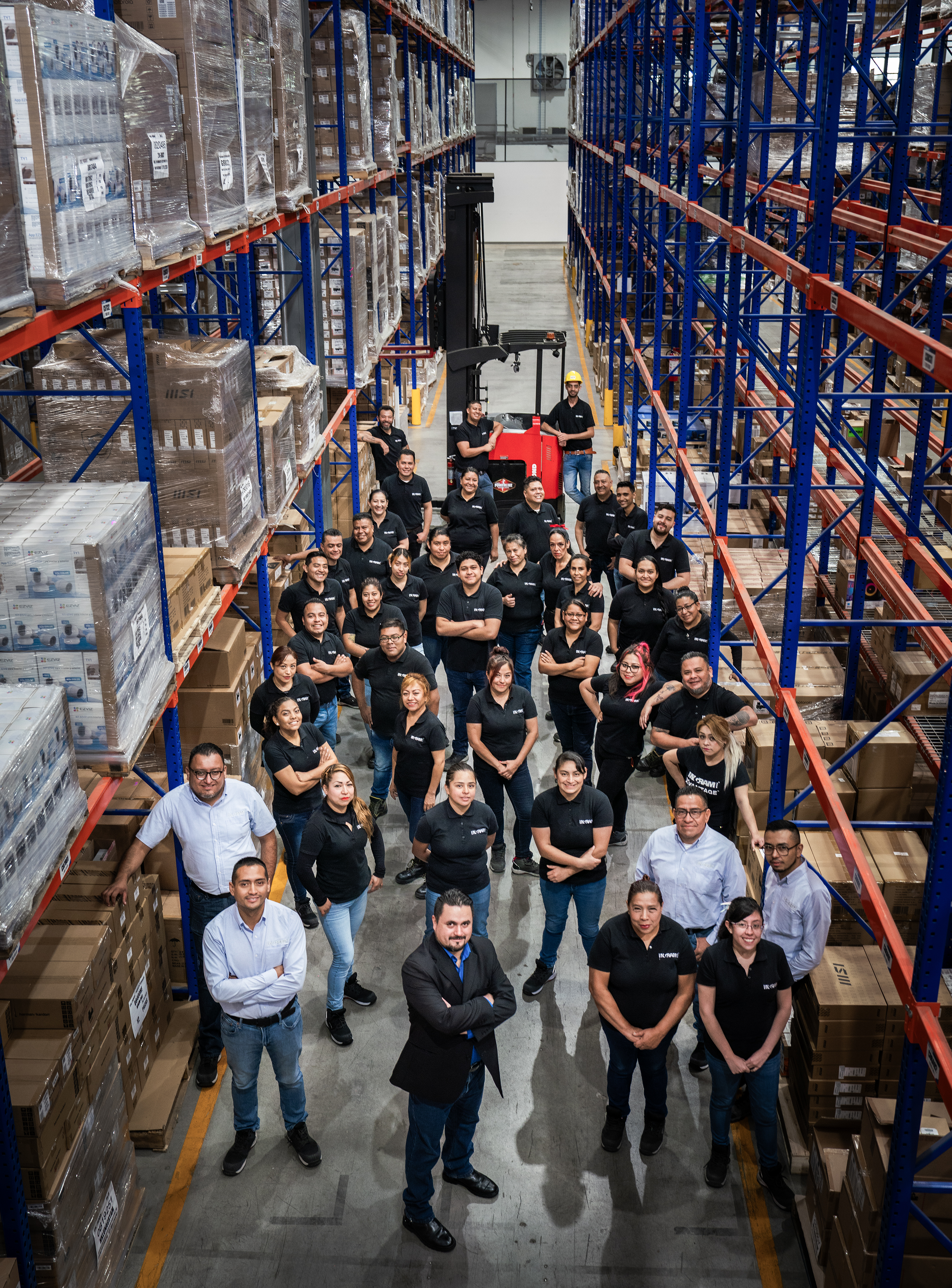 a group of people standing in a warehouse