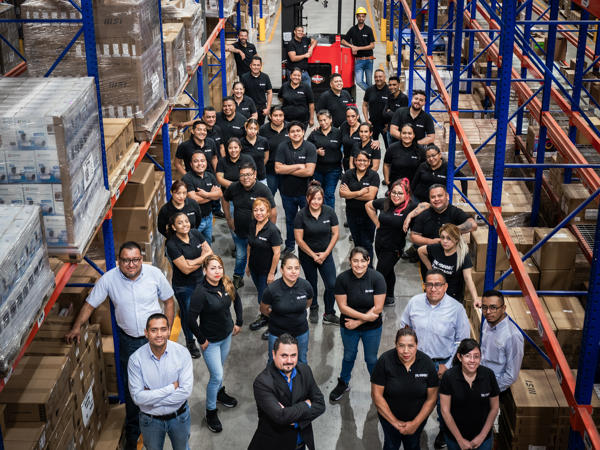 a group of people standing in a warehouse