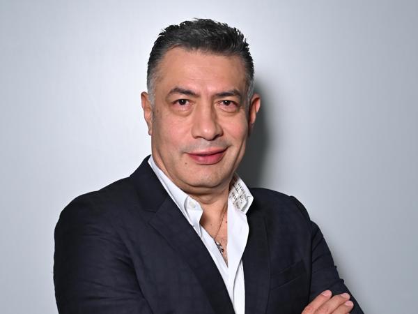 a person in a suit with his arms crossed