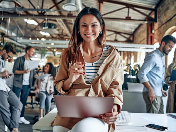 a person sitting on a table with a laptop