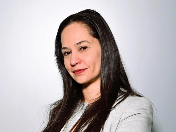 a person with long hair and arms crossed