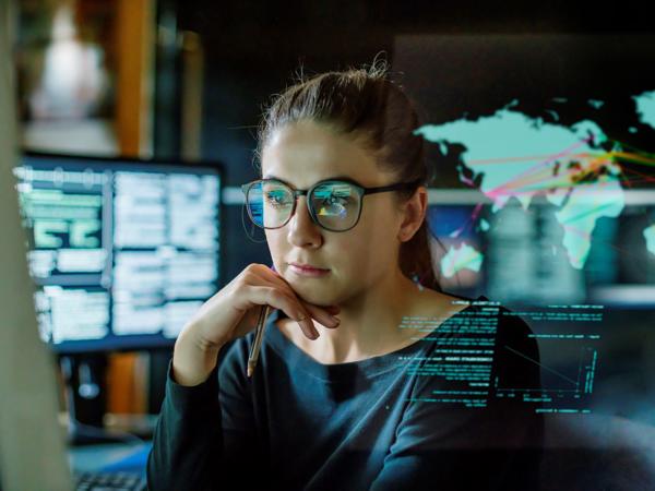 a person sitting in front of a computer screen