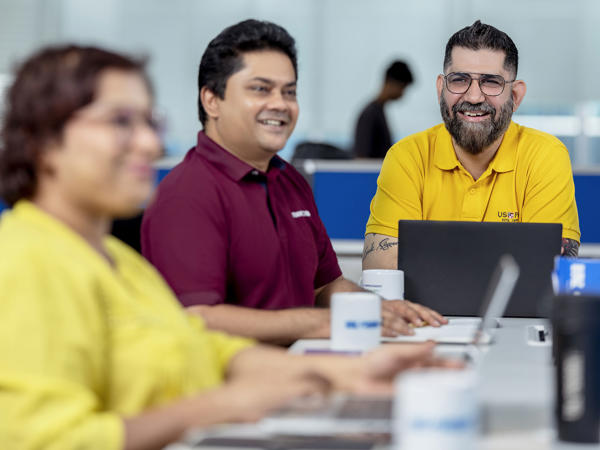 Three Associates Engaging In A Meeting