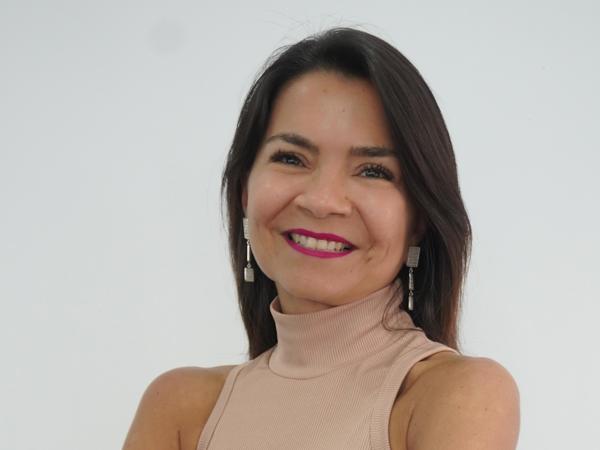 a person with arms crossed smiling