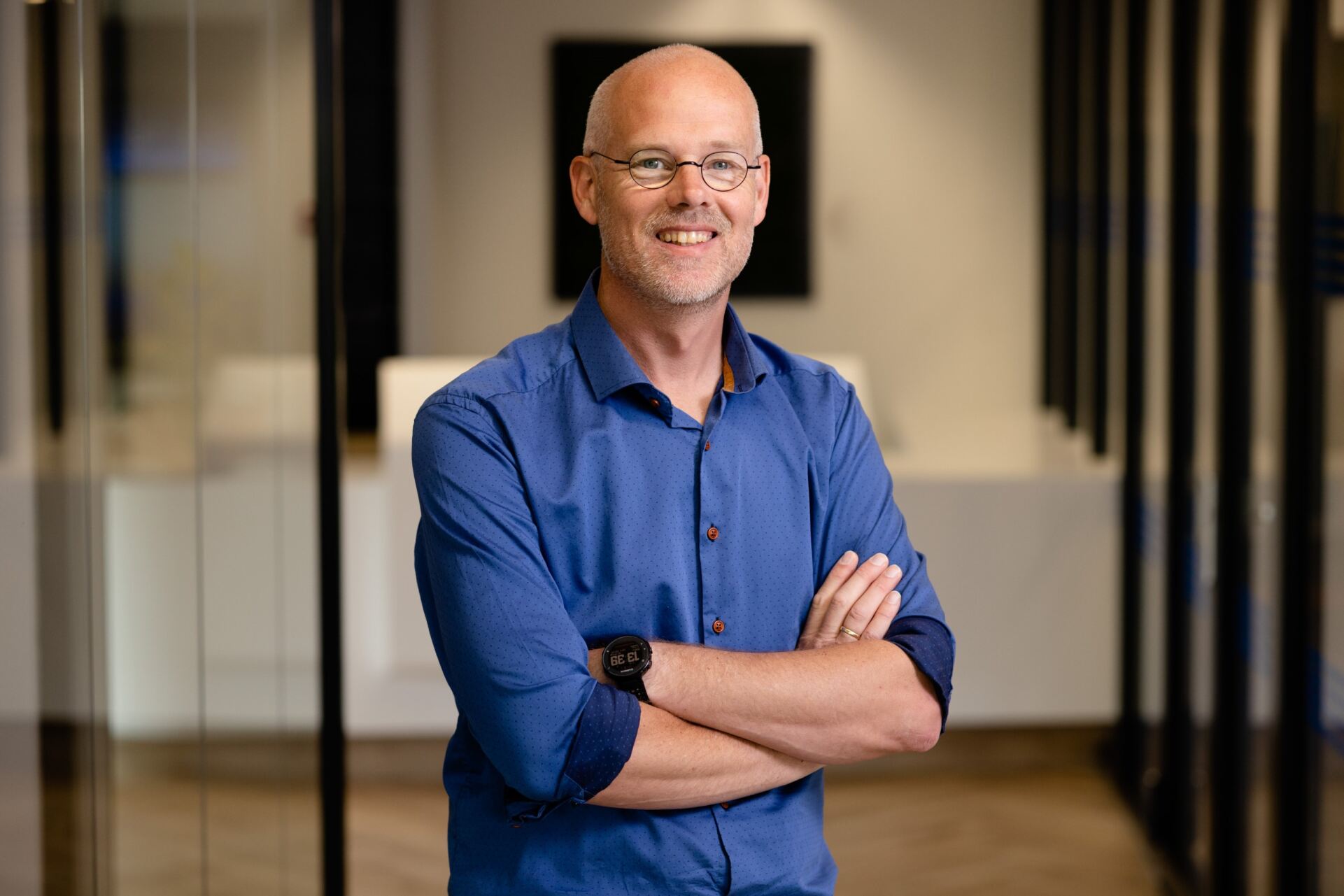 a person wearing glasses and a blue shirt