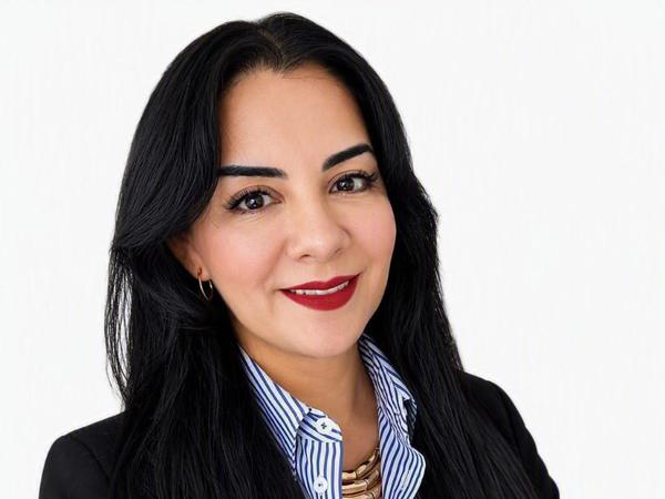 a person with long black hair wearing a black suit and striped shirt
