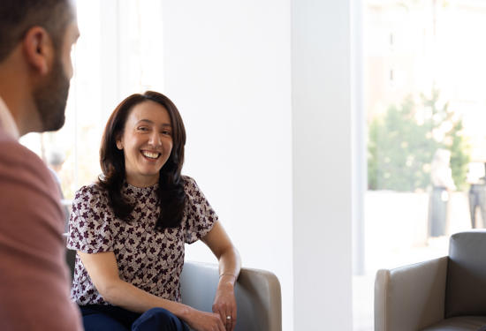 a person sitting in a chair and smiling