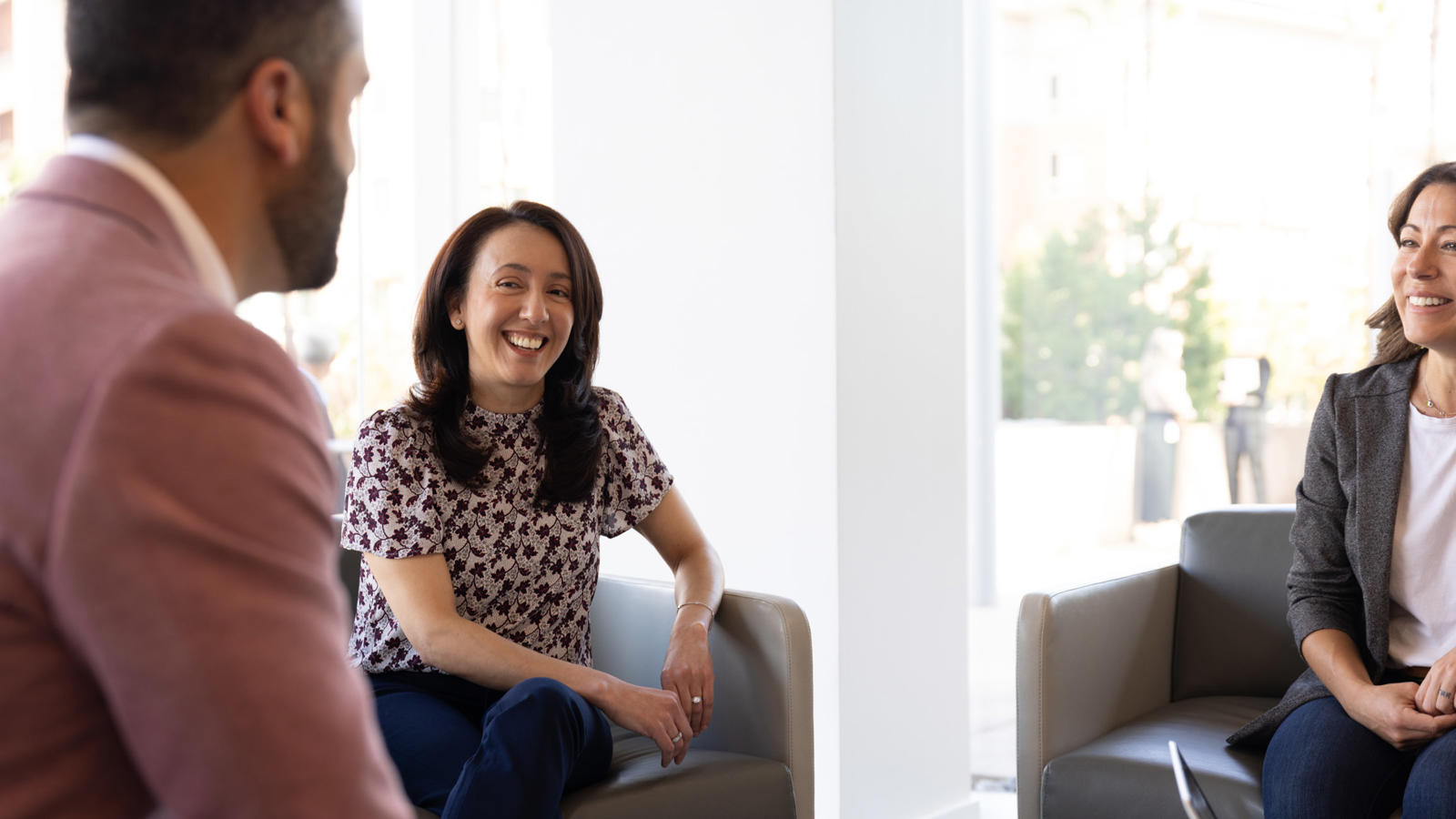 a person sitting in a chair and smiling