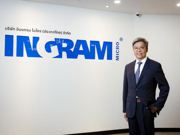 a person in a suit standing in front of a sign