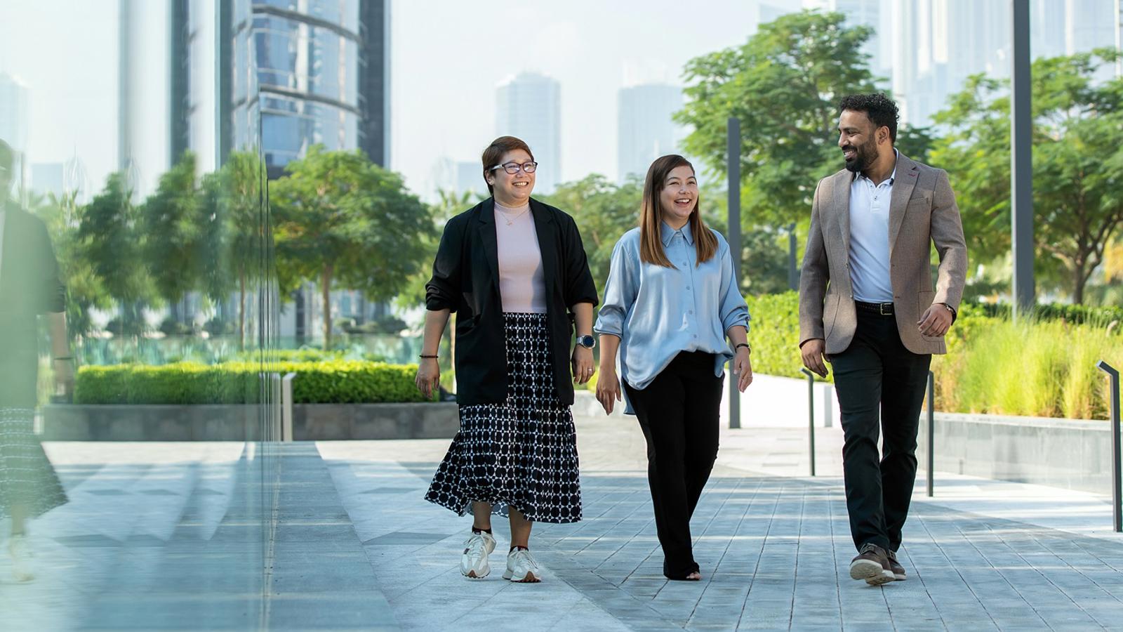 a group of people walking on a sidewalk
