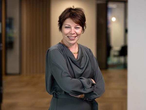 a person smiling with her arms crossed