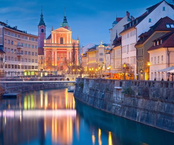 a river with buildings and lights