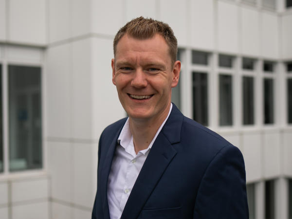 a person in a suit smiling