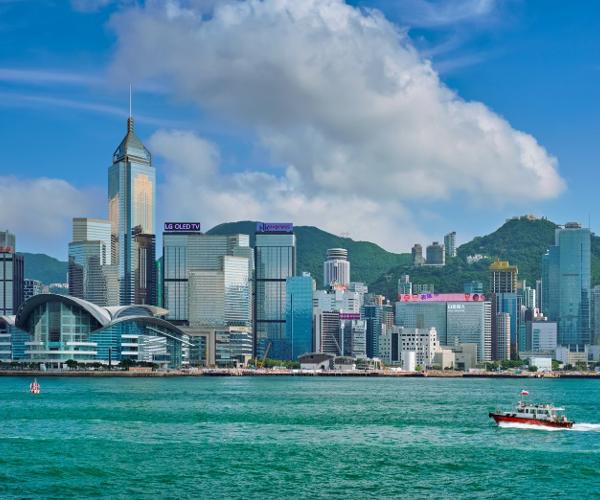 a boat on the water with Victoria Harbour in the background