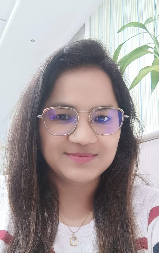 a person wearing glasses and smiling