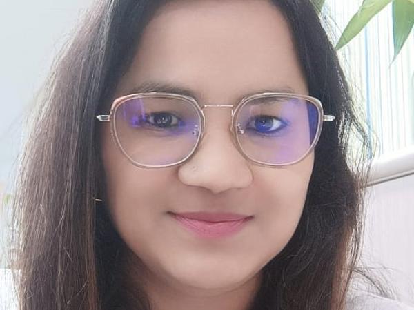 a person wearing glasses and smiling