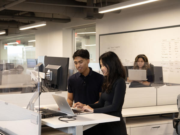 a person and person working on a laptop