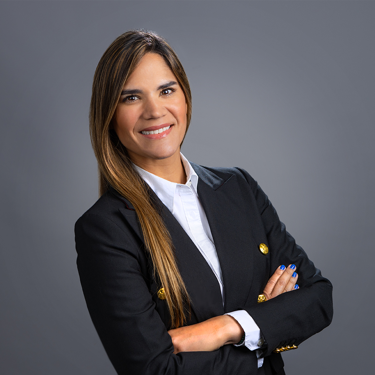 a person in a black suit with her arms crossed