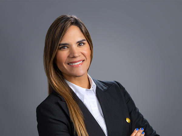 a person in a black suit with her arms crossed