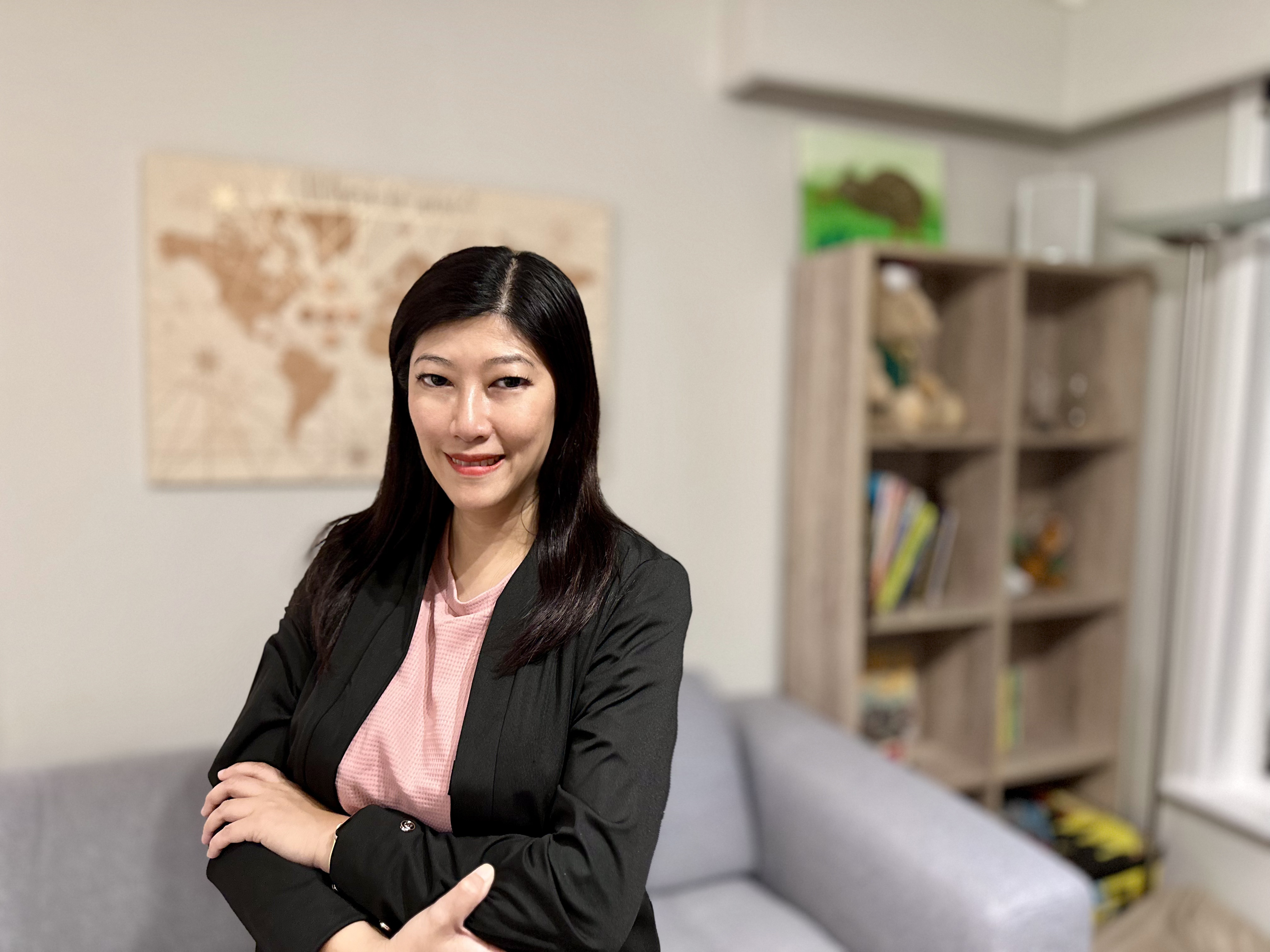 a person standing in a room with her arms crossed