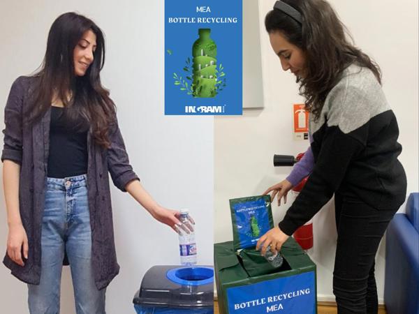 a person putting a bottle into a recycle bin