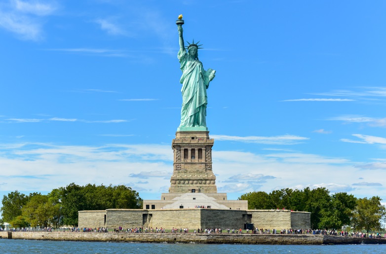 a statue of liberty with people around it