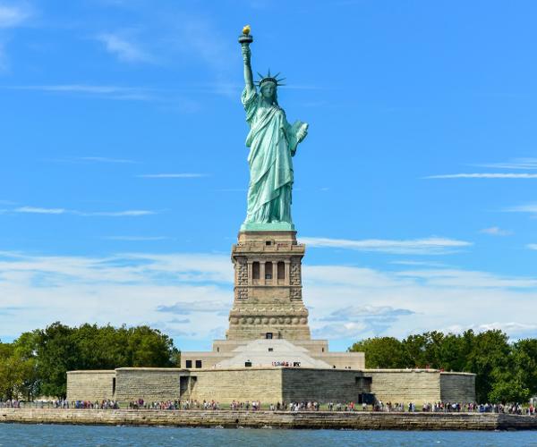 a statue of liberty with people around it