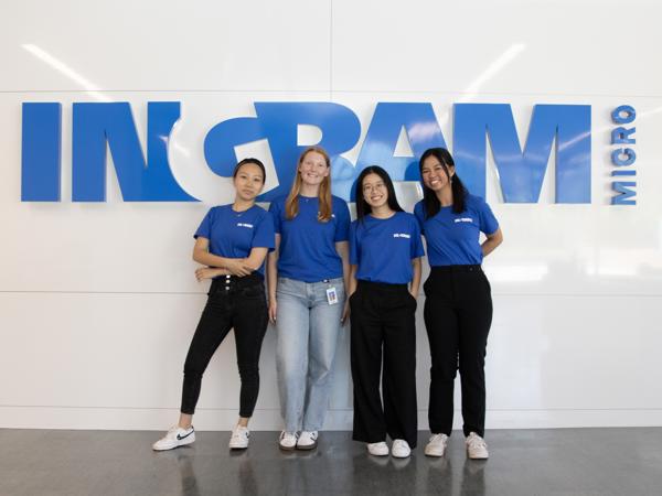 a group of women standing in front of a sign