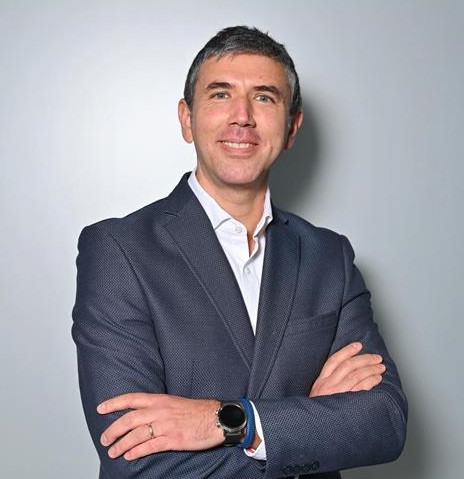 a person in a suit with his arms crossed