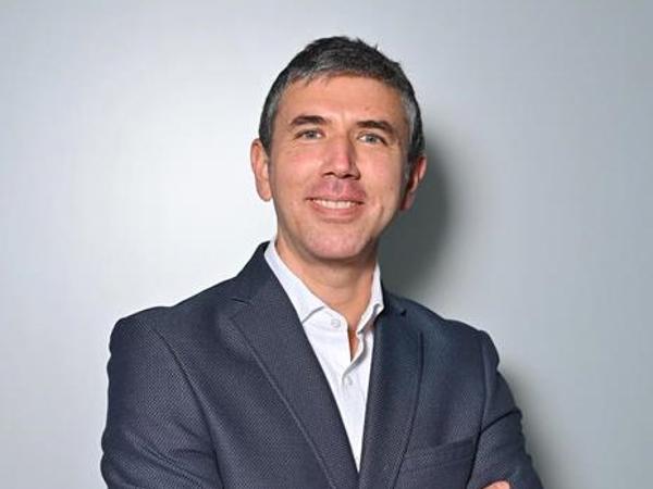a person in a suit with his arms crossed