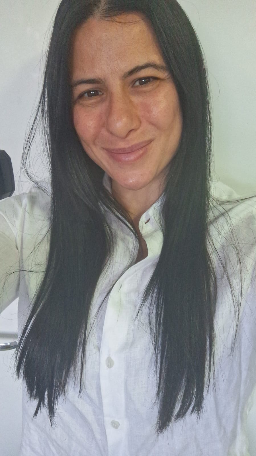 a person with long black hair smiling