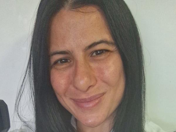 a person with long black hair smiling