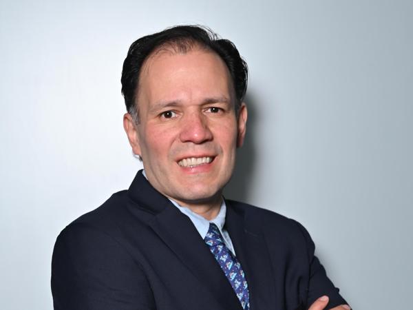 a person in a suit with his arms crossed